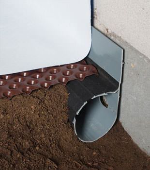 Closeup of a crawl space drainage system installed in Sylacauga
