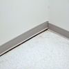 A partition wall separating from the floor in a Enterprise home.
