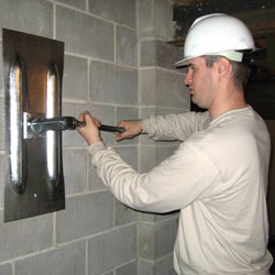 installing a wall anchor to repair an bowing foundation wall in Gadsden